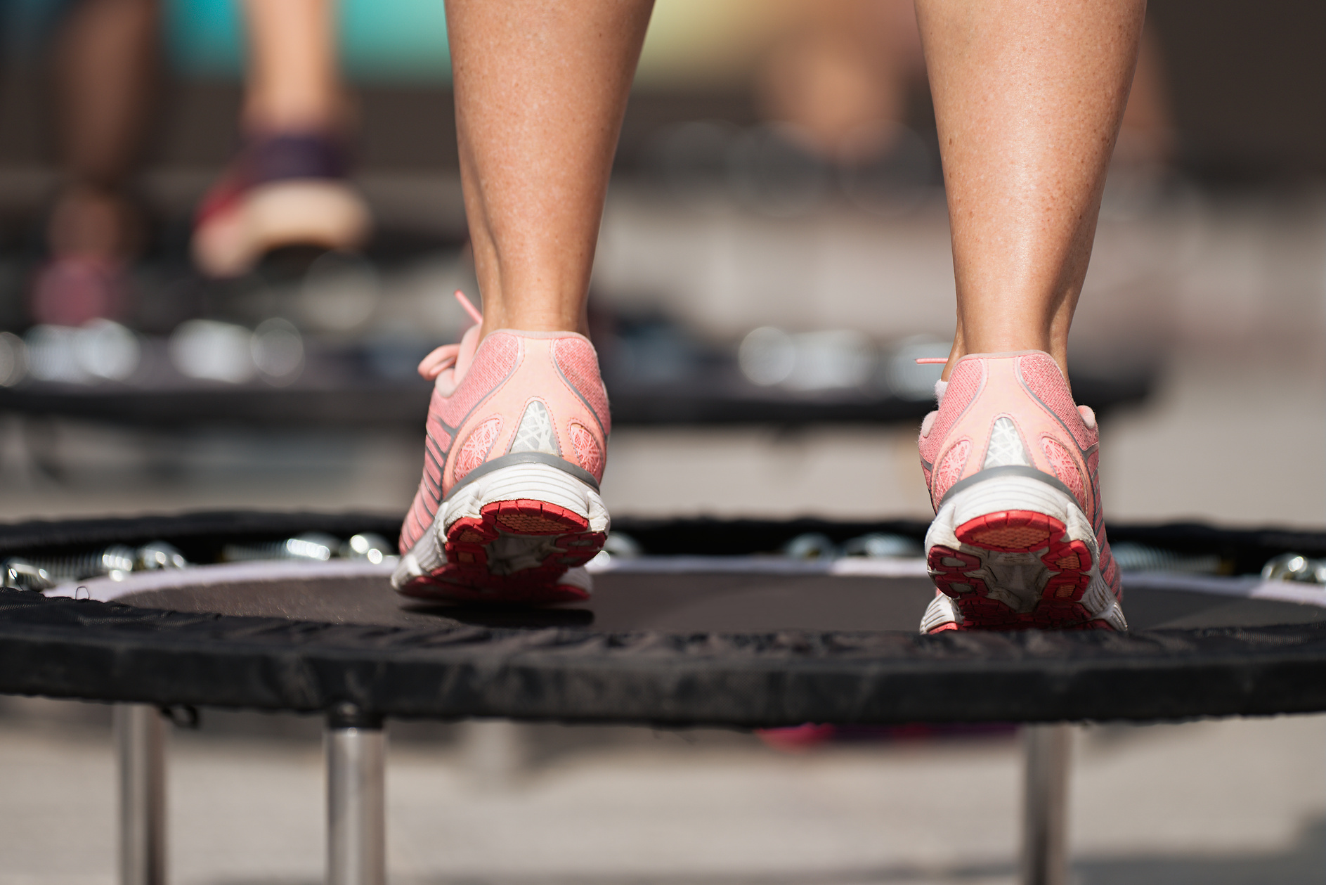 Fitness women jumping on small trampolines