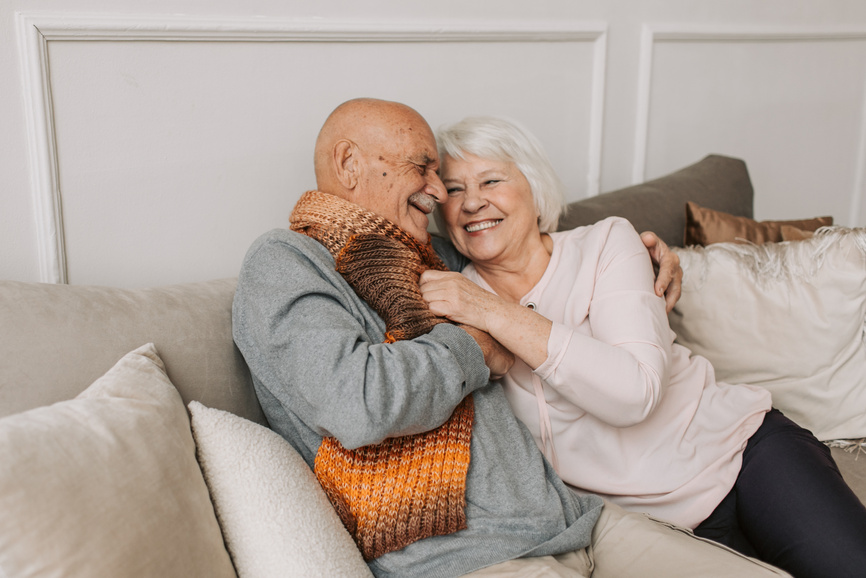 Man in Gray Sweater Hugging Woman Beside Him