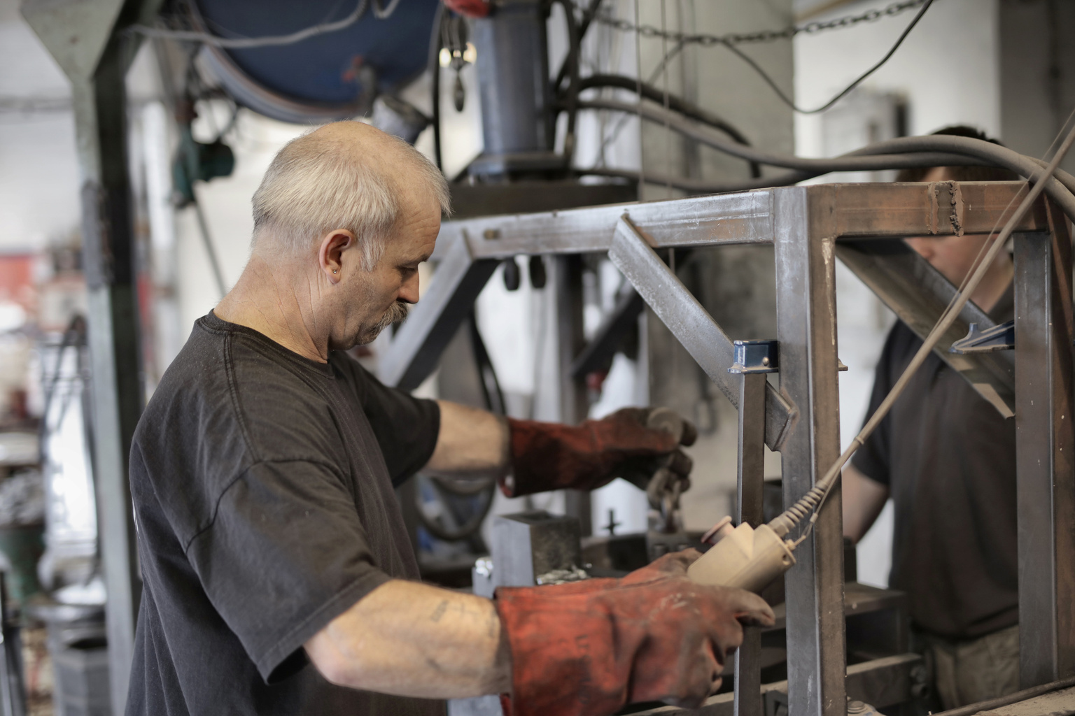 Aged white hair handyman working on machine