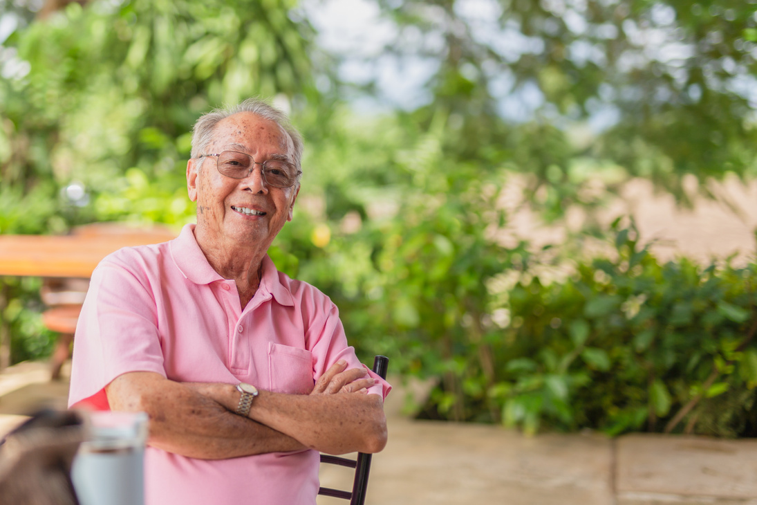 Portrait asian elderly man 83 years old with toothy smile sittin